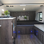Clipper 12.0TD Back to Front Showing Sink, Refrigerator, Cooktop, Bed with Overhead Cabinets and Gaucho Couch May Show Optional Features. Features and Options Subject to Change Without Notice.