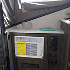 Clipper 12.0TD Cabinet with Air Conditioner, Controls for the RV, and Radio May Show Optional Features. Features and Options Subject to Change Without Notice.