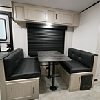 Dinette with Two Booths 1 Door Underneath Booth, 2 Overhead Cabinets Above Dinette May Show Optional Features. Features and Options Subject to Change Without Notice.
