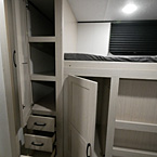 Bunk Room Wardrobe Door Open with 2 Shelves, 3 Drawers Open Under Wardrobe, Large Storage Compartment Open May Show Optional Features. Features and Options Subject to Change Without Notice.