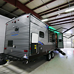 Rear 3/4 View of Door Side with Camp Kitchen Open, Awning Extended with LED Lights (Shown in Green), Optional Solid Steps Extended
 May Show Optional Features. Features and Options Subject to Change Without Notice.