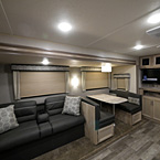 Jiffy Sofa (Shown in Java Décor) with Flip Down Cup holders and Two Throw Pillows, Booth Dinette with Two Storage Cabinets, Entertainment Center with Two Storage Cabinets Above 32 Inch T.V., Two Cabinet Doors Below May Show Optional Features. Features and Options Subject to Change Without Notice.