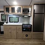 Kitchen- Three Cabinets Next to Microwave, Grey Back Splash, Stainless Steel Sink Cover with Faucet, Oven with Three Burner Stove and Glass Top, Two Drawers and Three Storage Cabinets Underneath, Eight Cubic Foot Stainless Steel Refrigerator 
 May Show Optional Features. Features and Options Subject to Change Without Notice.