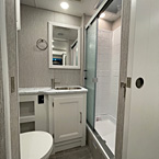 Full view of bathroom, Stainless sink, Glass Shower Door, Skylight Over the Shower, One Piece ABS Shower Surround, 
 May Show Optional Features. Features and Options Subject to Change Without Notice.