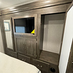 View of LED TV bedroom, with drawers, with cabinet open and storage space, mirrors
 May Show Optional Features. Features and Options Subject to Change Without Notice.