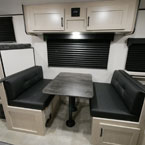 Two Cabinet Doors Over head of Booth Dinette with Storage Below One of the Booths.
 May Show Optional Features. Features and Options Subject to Change Without Notice.