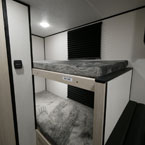 Two Bunks with Window in Each Bunk and Pleaded Night Shades.
 May Show Optional Features. Features and Options Subject to Change Without Notice.