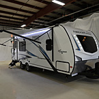 3 / 4 Front Cap and Door Side with Exterior Lights On, Awning Extended, and Steps Extended
 May Show Optional Features. Features and Options Subject to Change Without Notice.