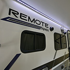 Door Side Showing LED Light Strip on in White, Exterior Speaks and Awning Extended. May Show Optional Features. Features and Options Subject to Change Without Notice.