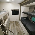Bunk House with Two Bunks, Storage Compartments and Cube Futon.
 May Show Optional Features. Features and Options Subject to Change Without Notice.