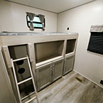 Bunk with Ladder, Storage and Shelving Compartments Below.
 May Show Optional Features. Features and Options Subject to Change Without Notice.