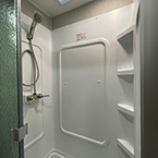 One Piece ABS Shower Surround with glass door and partial view of skylight over shower May Show Optional Features. Features and Options Subject to Change Without Notice.