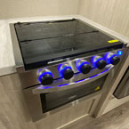 Three Burner Cook Top with Glass Cover and Stove with Blue LED Lights Shown On.
 May Show Optional Features. Features and Options Subject to Change Without Notice.