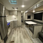Interior From Front to Back- Kitchen Galley, Into Bunkroom, Dinette and Part of Jiffy Sofa.
 May Show Optional Features. Features and Options Subject to Change Without Notice.