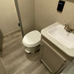 Foot Flush Toilet Next to Single Bowl Vanity.
 May Show Optional Features. Features and Options Subject to Change Without Notice.