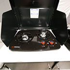 Two Burner Cook Top with Top Shown Open Next to Single Bowl Sink.
 May Show Optional Features. Features and Options Subject to Change Without Notice.