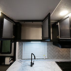 Three Cabinets Overhead of Sink Shown Open.
 May Show Optional Features. Features and Options Subject to Change Without Notice.