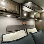RV King bed in bedroom, with overhead cabinets and CPAP Cabinet
 May Show Optional Features. Features and Options Subject to Change Without Notice.