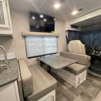 View of dinette and tv, partial view of kitchen and sink and swivel chairs in cockpit
 May Show Optional Features. Features and Options Subject to Change Without Notice.