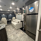 Stainless Steel Double Door Refrigerator with view of sofa with overhead cabinets
 May Show Optional Features. Features and Options Subject to Change Without Notice.