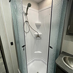 View of One Piece ABS Shower Surround, Retractable Shower Door and Skylight Over Shower
 May Show Optional Features. Features and Options Subject to Change Without Notice.