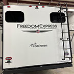 Rear view of unit with ladder to roof and brand logo May Show Optional Features. Features and Options Subject to Change Without Notice.